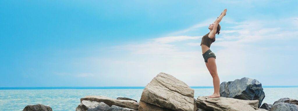 Mujer mediando en la playa